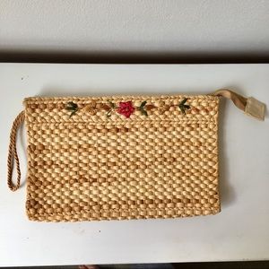 Woven clutch/ wristlet. Floral band detail